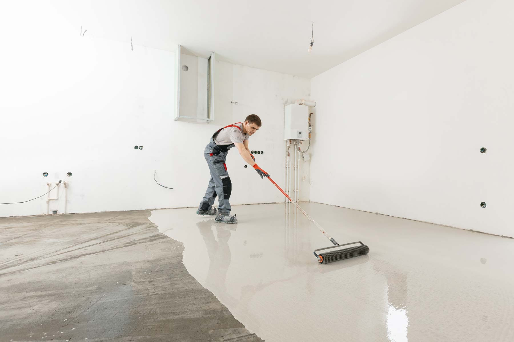 homeguide-worker-adding-epoxy-garage-floor-coating